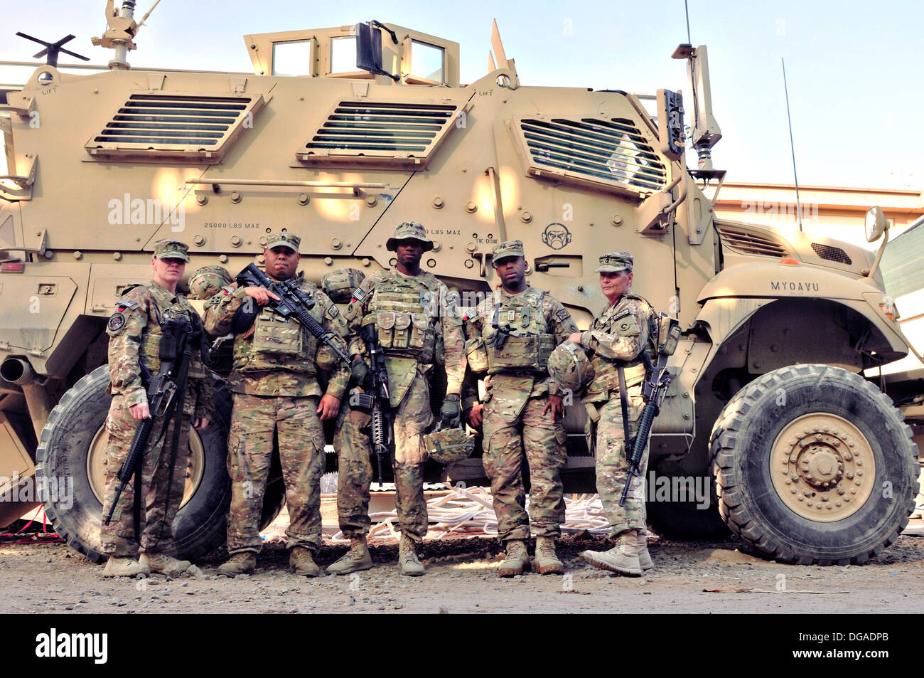 U.S. Soldiers stand in front of a mine-resistant, ambush-protected vehicle at the New Kabul Compound September 26, 2013 in Kabul province, Afghanistan. Stock Photo