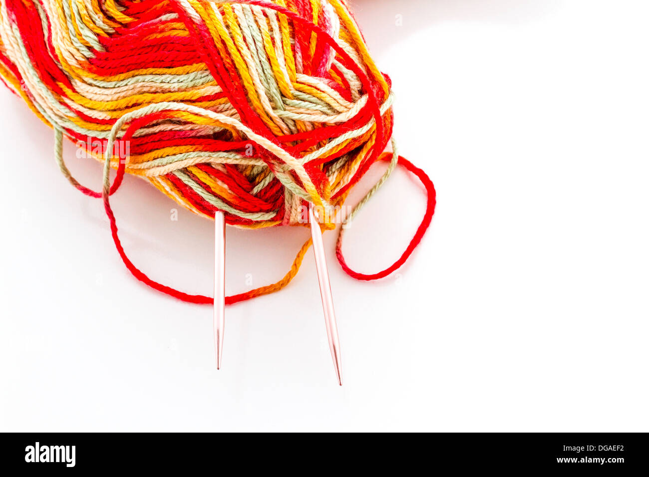 Knitting with multi colored yarn with orange, red, and yellow tones Stock  Photo - Alamy