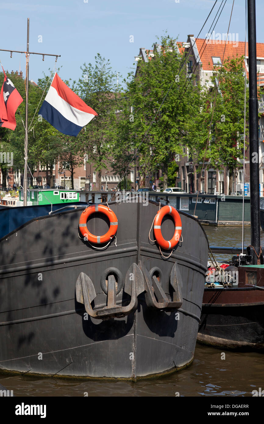 Dutch boat in the canal of Amsterdam Stock Photo