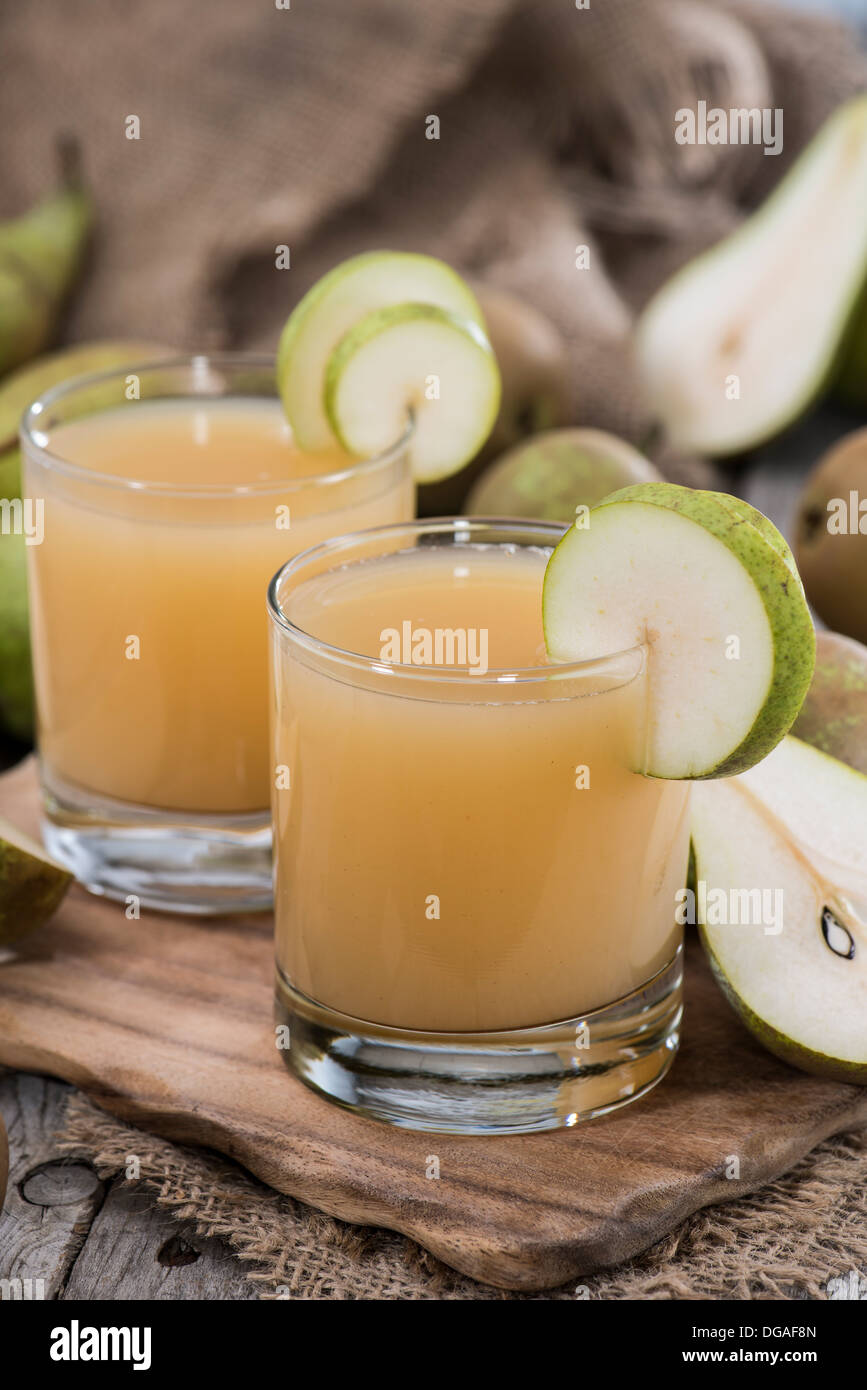 Glass filled with freh made Pear Juice Stock Photo - Alamy