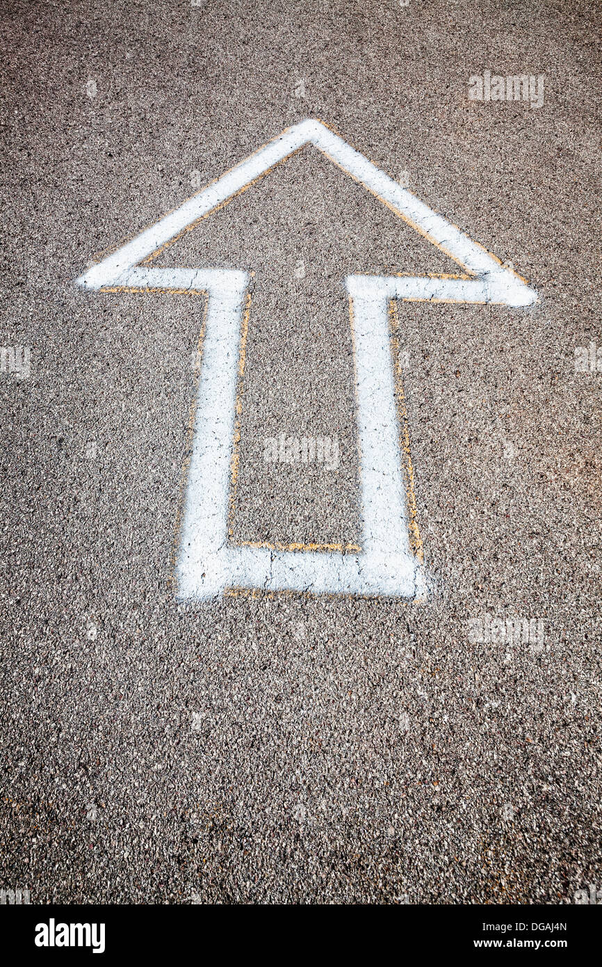 Arrow painted on asphalt Stock Photo