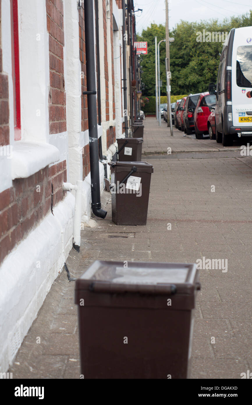 Food waste bins on street of terraced houses Cardiff Wales UK Stock