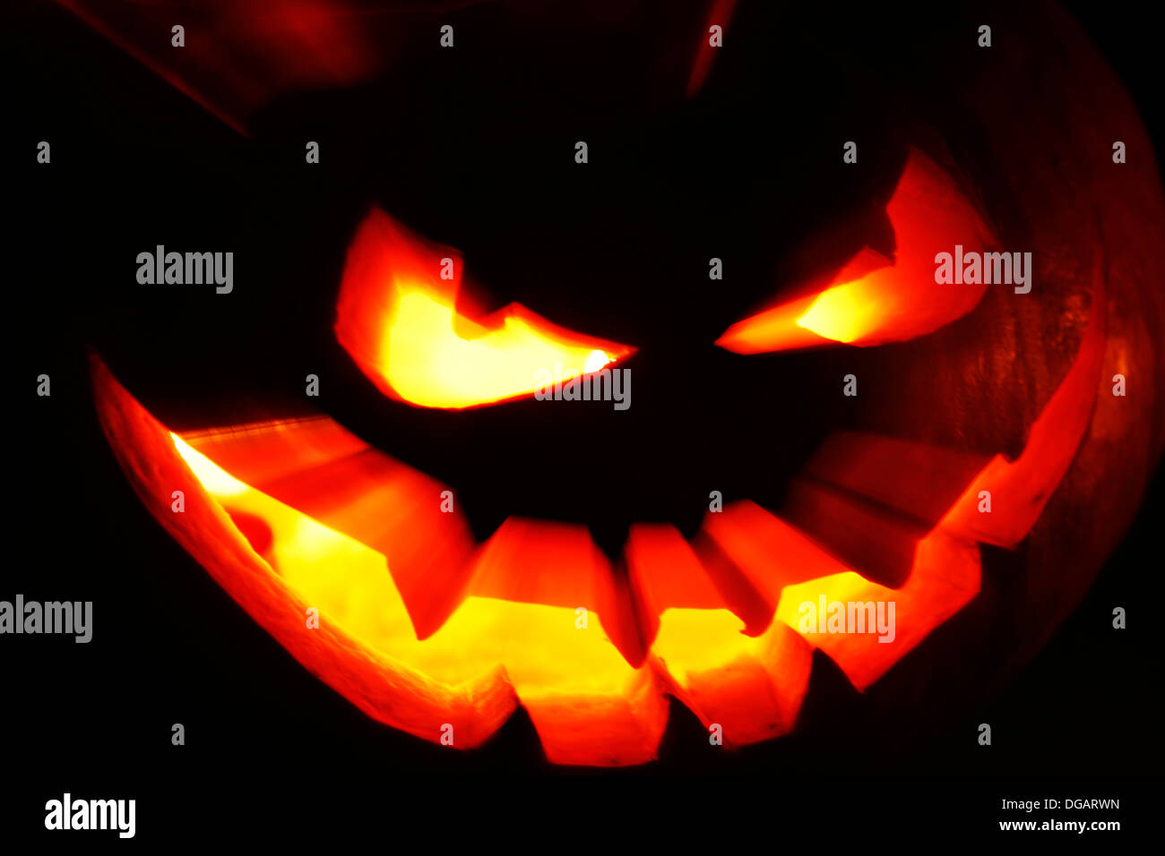 Halloween pumpkin with scary face on black background Stock Photo - Alamy