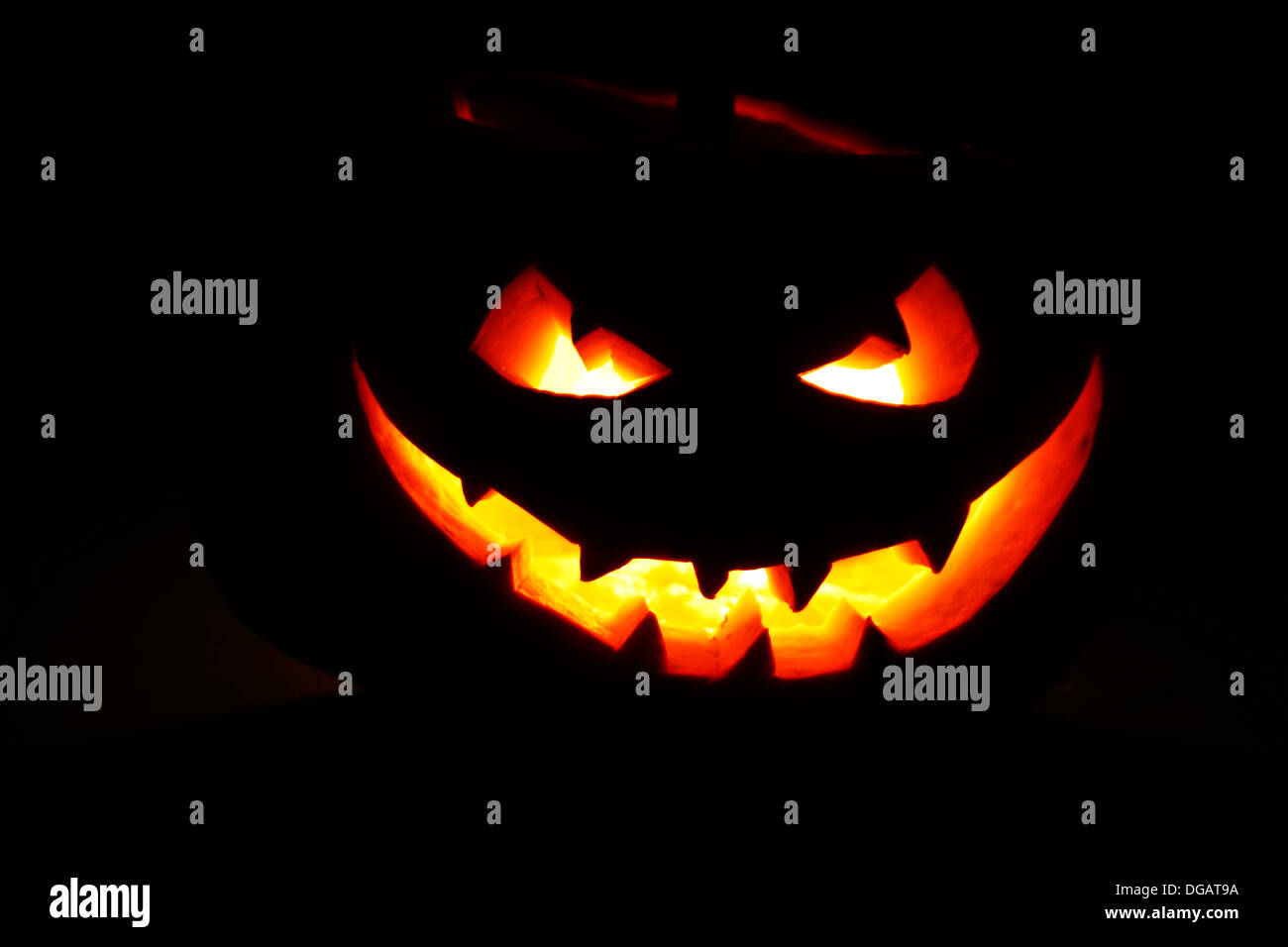 Halloween pumpkin with scary face on black background Stock Photo - Alamy