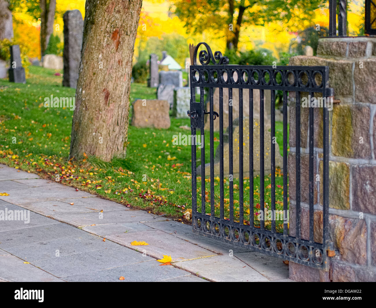 cross radiating in evening sun, autumnal foliage Stock Photo