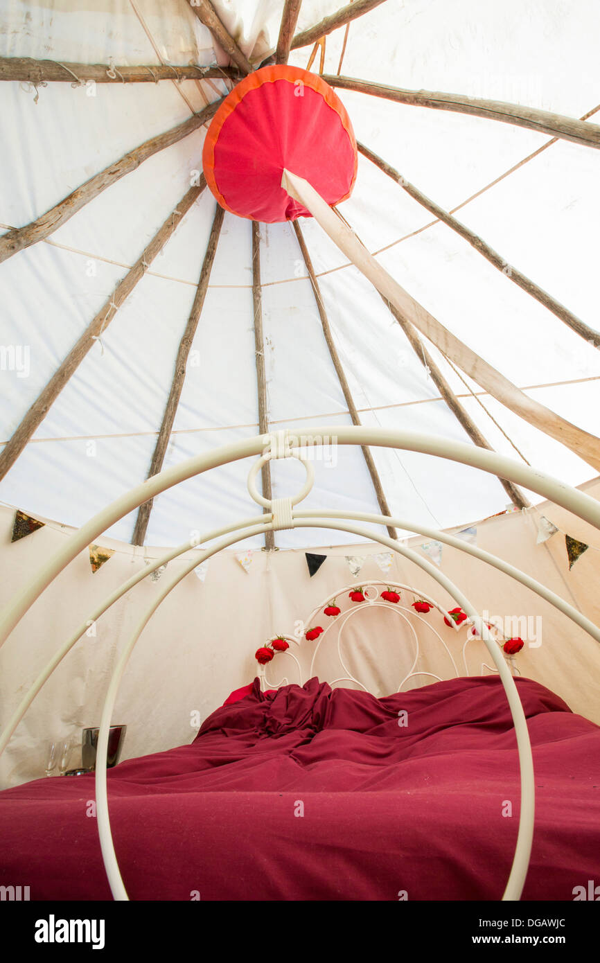 A double bed in a wigwam used as the honeymoon suite for a green