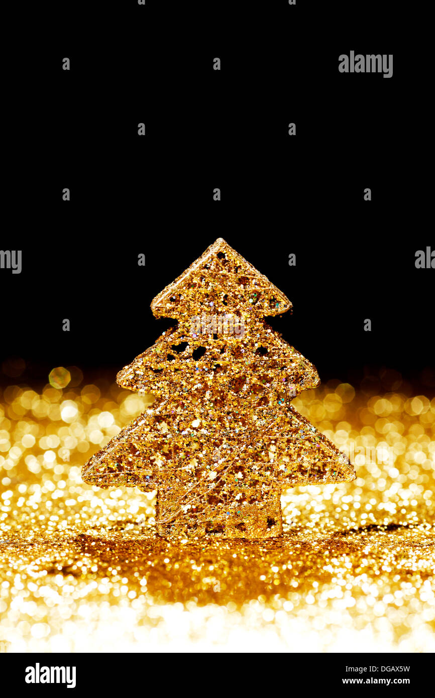 Golden christmas fir tree decoration on glitter background with black ...
