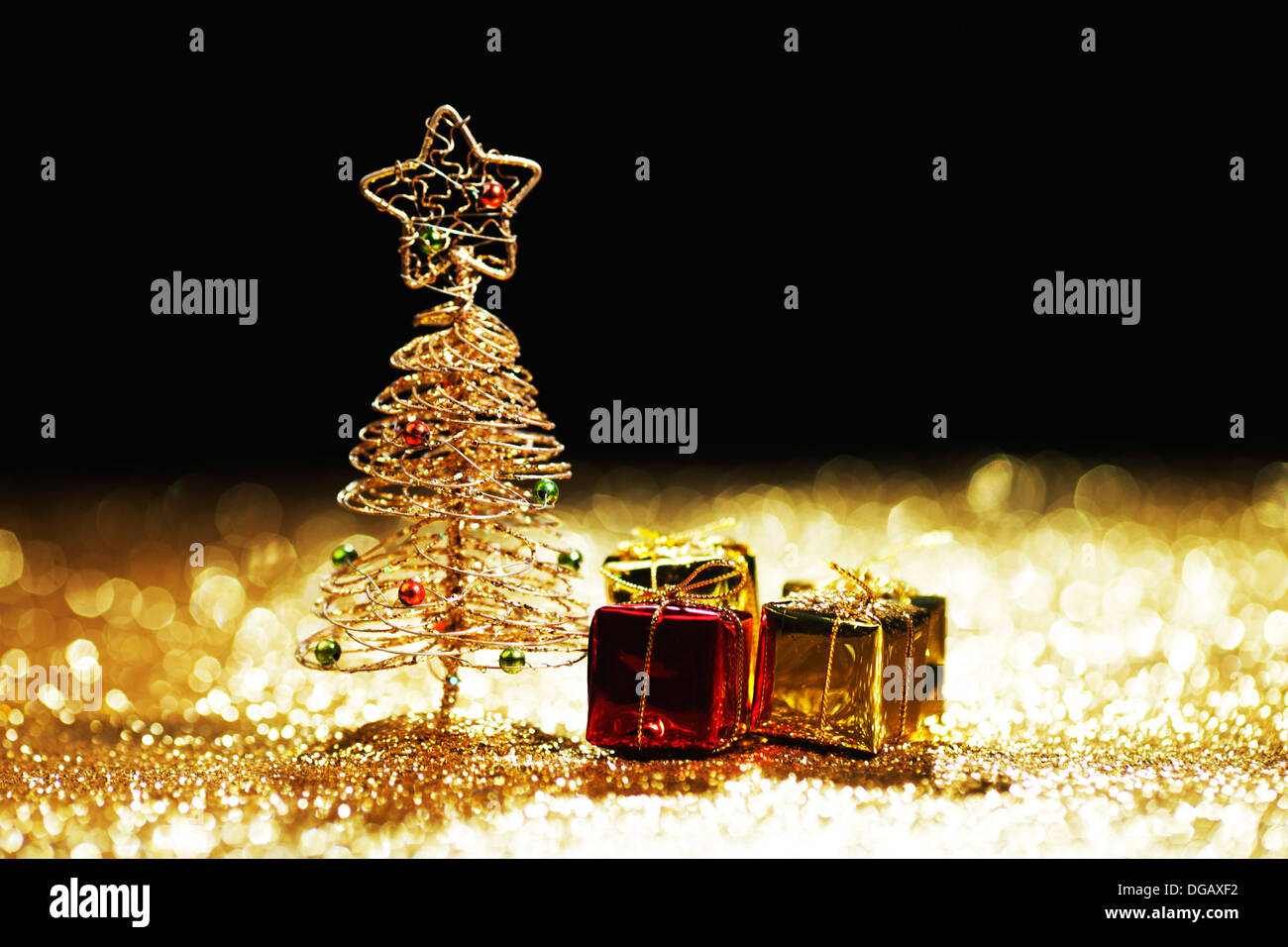 Golden christmas fir tree decoration and gifts on glitter background ...