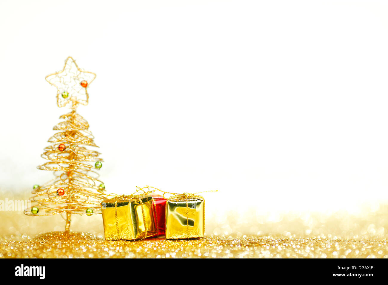 Golden christmas fir tree decoration and gifts on glitter background ...