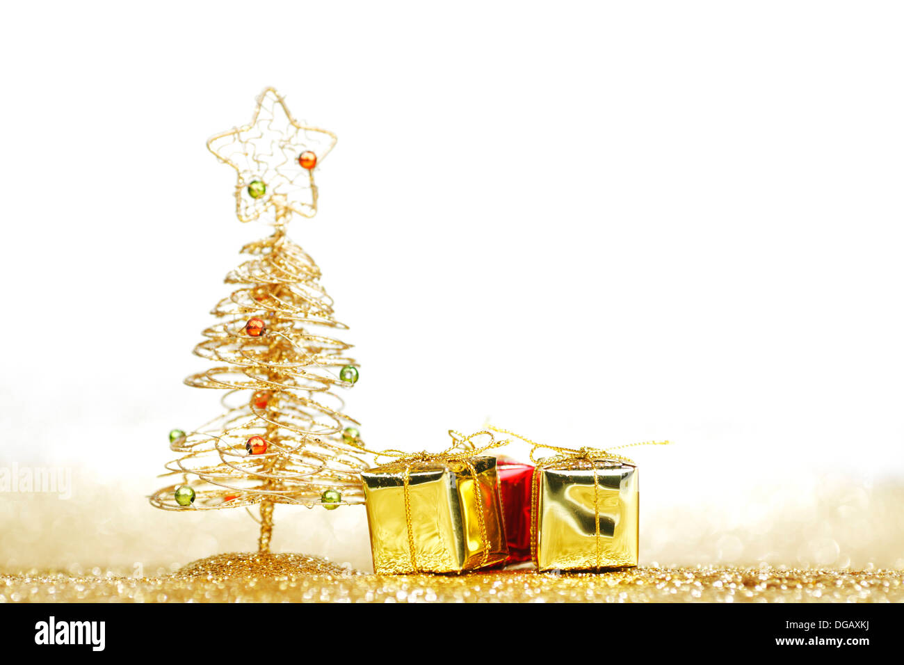 Golden christmas fir tree decoration and gifts on glitter background ...