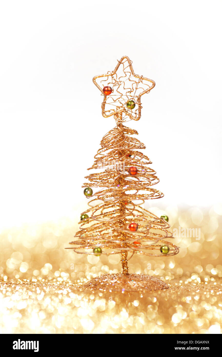 Golden christmas fir tree decoration on glitter background with white ...