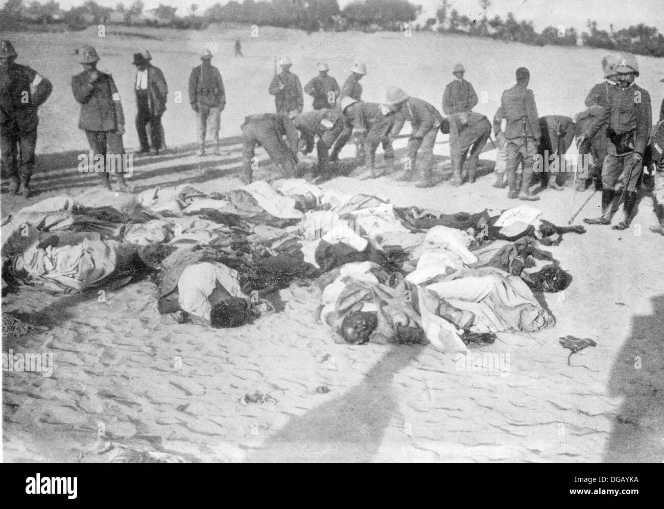Execution of 30 Turks dressed as Arabs in Tripoli. Italian soldiers and dead bodies of Turkish men during the Turco-Italian War Stock Photo