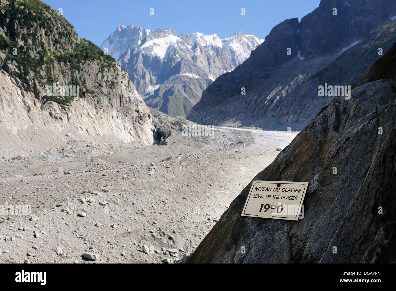 A sign showing the extent of glacial retreat recently - the Mer de Glace now far below the sign showing the level in 1990 Stock Photo