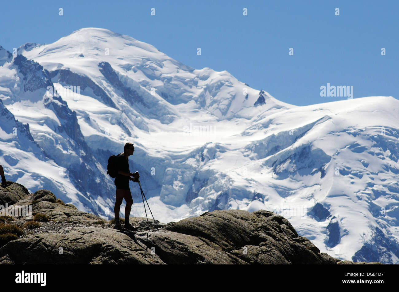 A lone walker at lac Blanc in the French Alps silhouetted against Mont Blanc, Chamonix, France Stock Photo