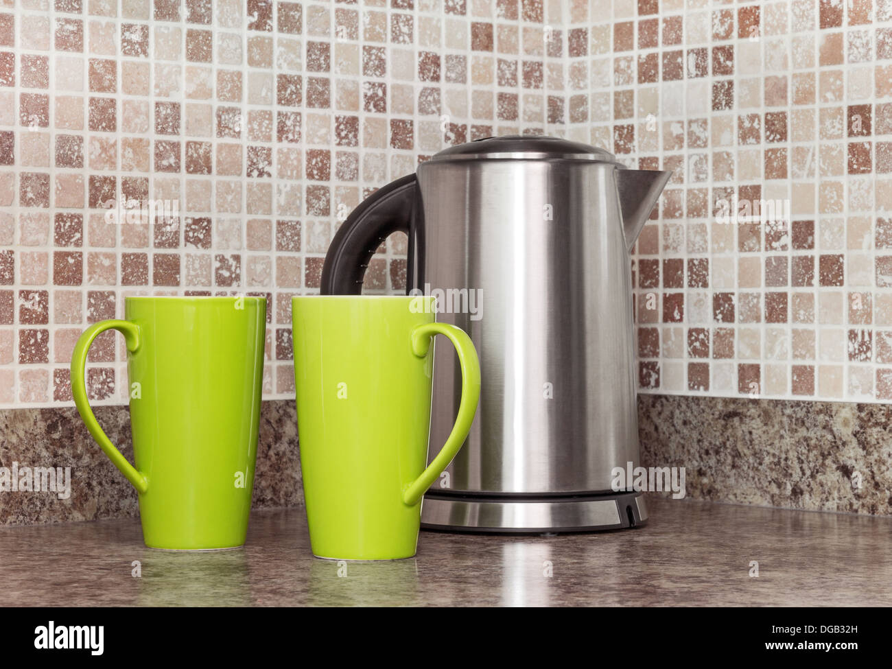Metal electric kettle and green cups in the kitchen Stock Photo Alamy