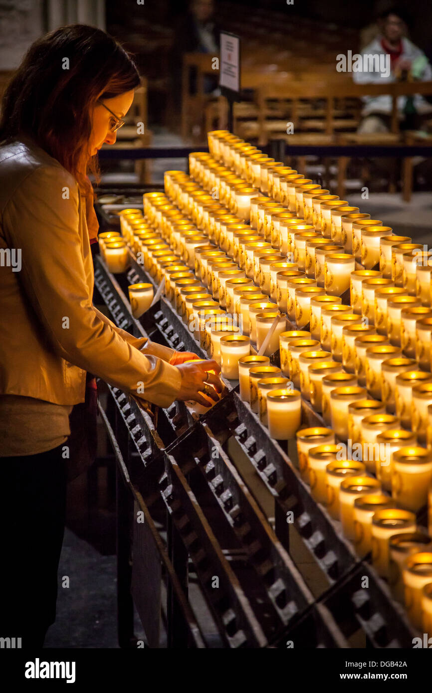 Lighting candle cathedral notre dame hires stock photography and