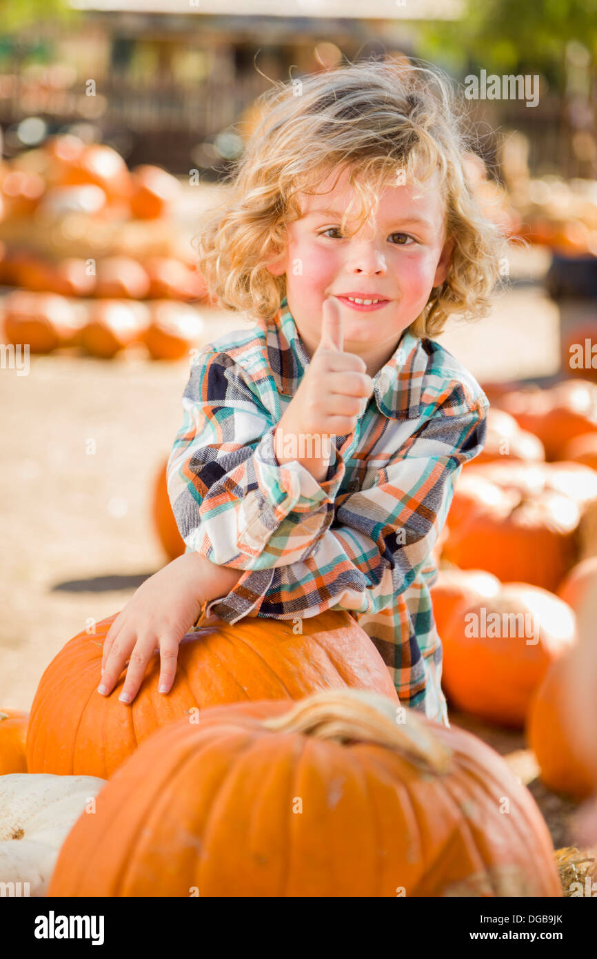 Adorable Little Boy Leaning on Pumpkin Gives a Thumbs Up in a Rustic ...