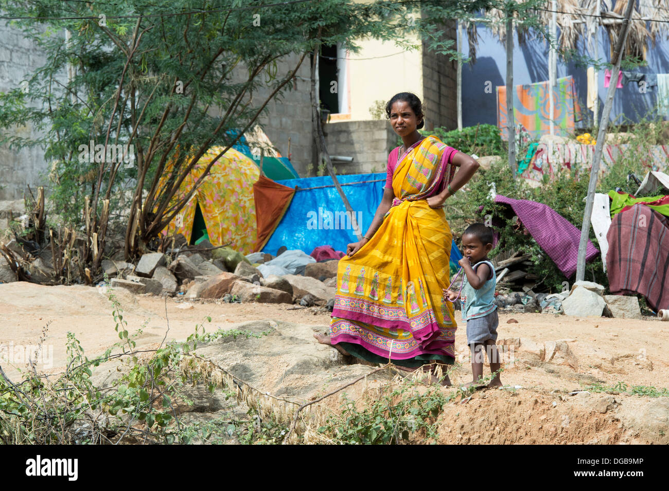 Lower caste Indian woman and child standing outside her bender / tent / shelter. Andhra Pradesh, India Stock Photo