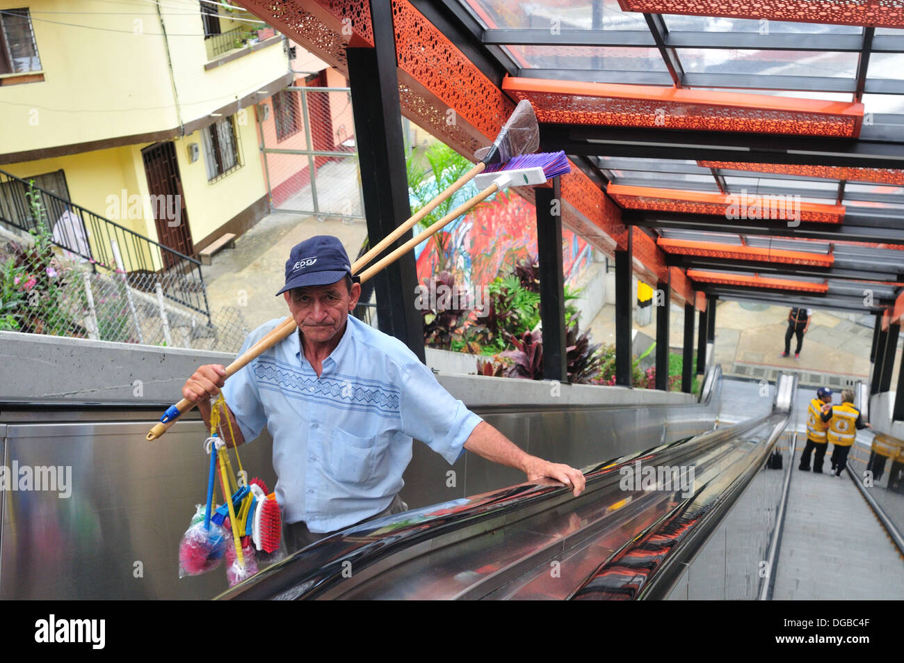 Broom salesman, Escalators , COMUNA 13 - 20 de Julio district in MEDELLIN .Department of Antioquia. COLOMBIA Stock Photo