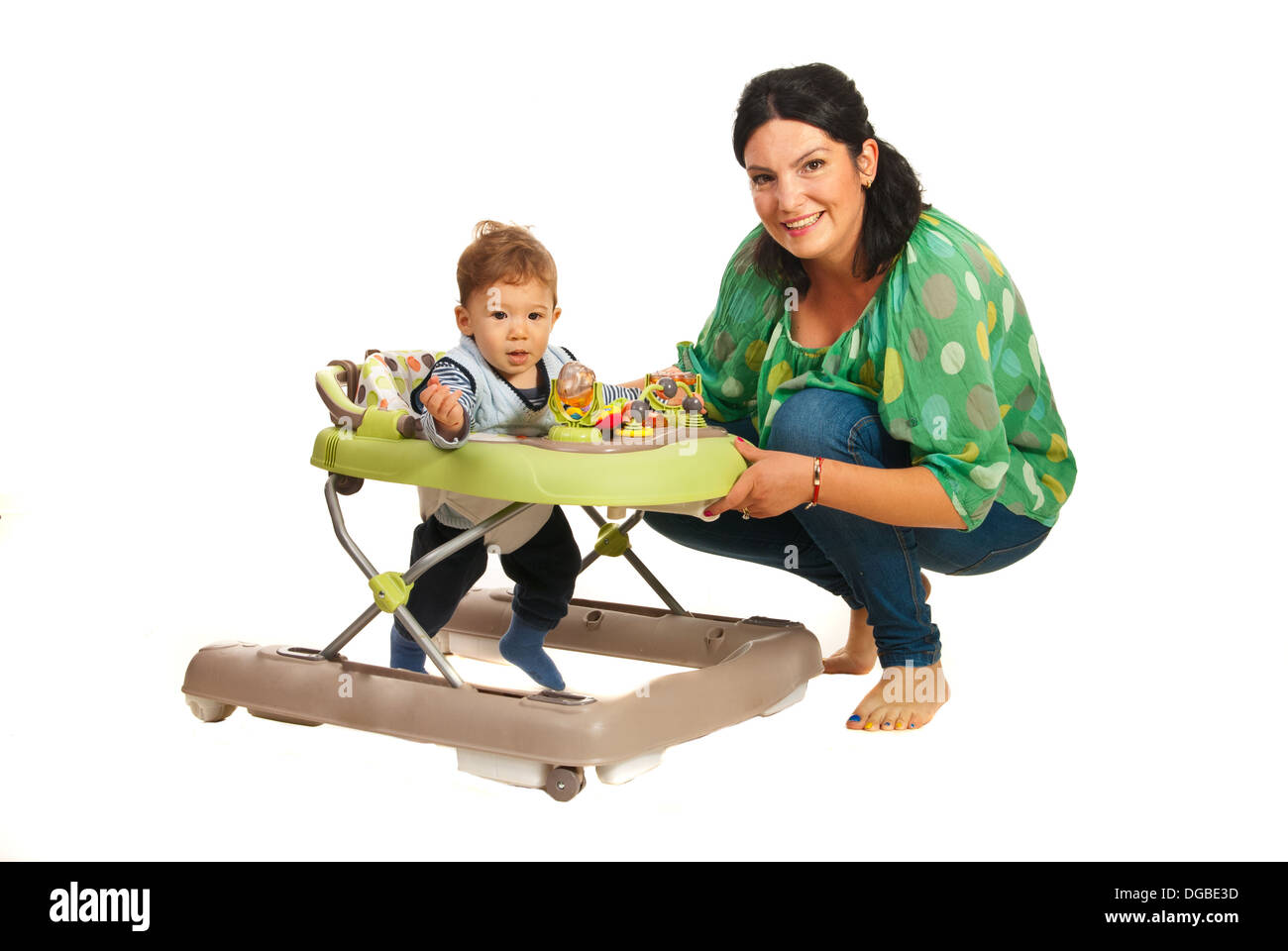 Mother teaching baby in walker in their home Stock Photo