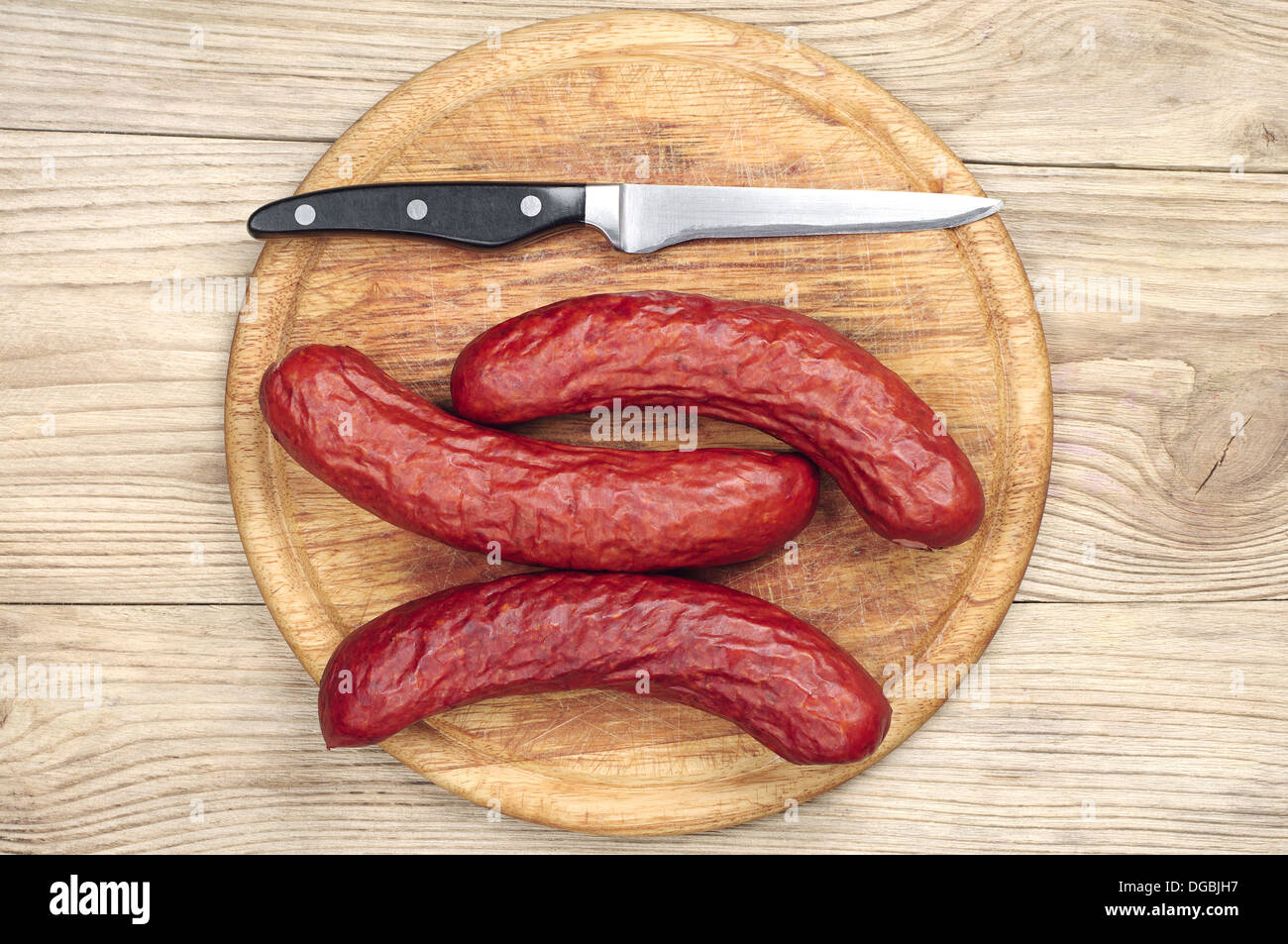 Homemade smoked sausage on a cutting board. Top view Stock Photo