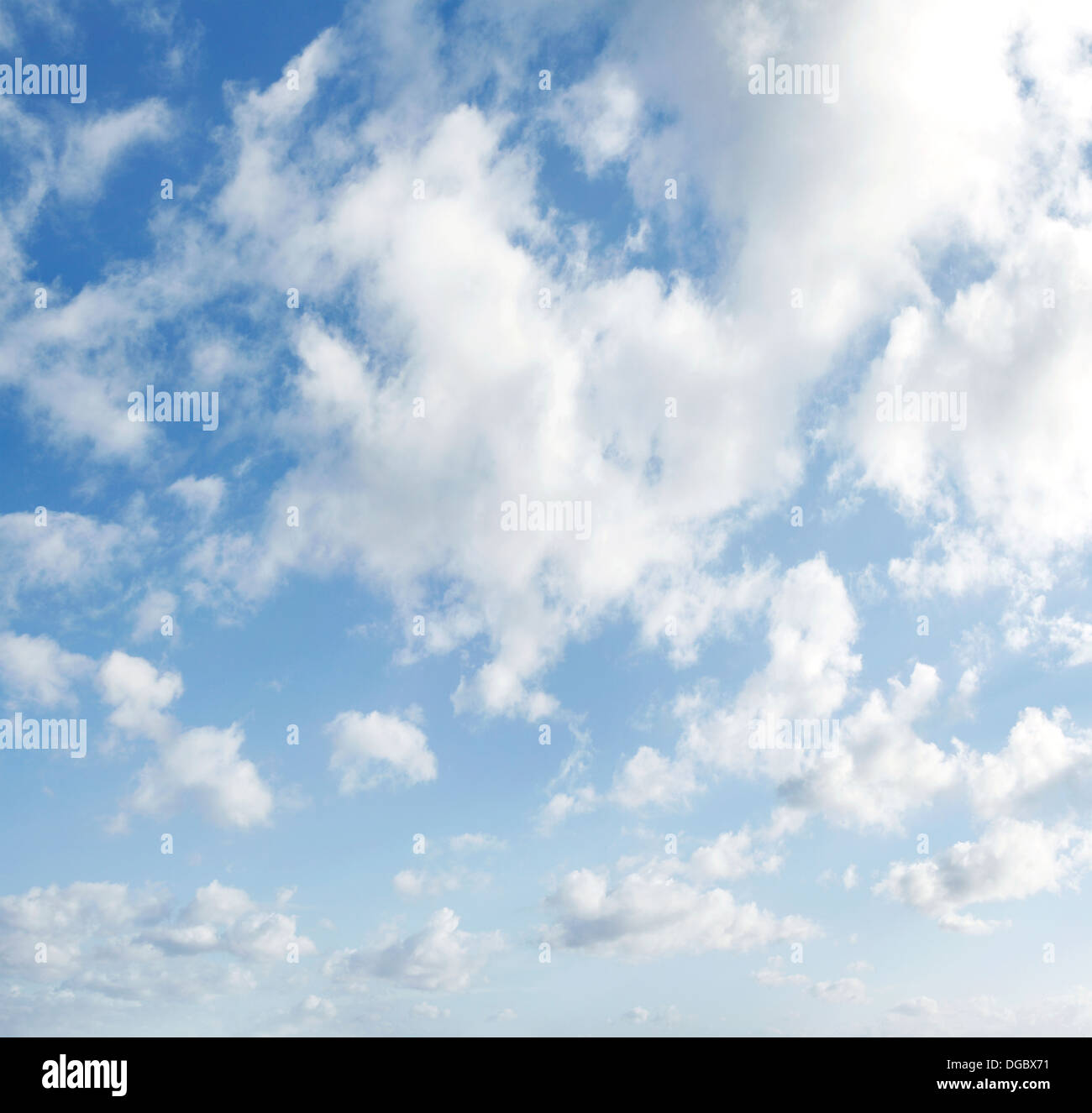 Fluffy clouds in a blue sky Stock Photo - Alamy