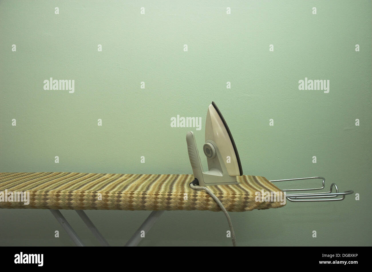 Simple iron on ironing board Stock Photo Alamy