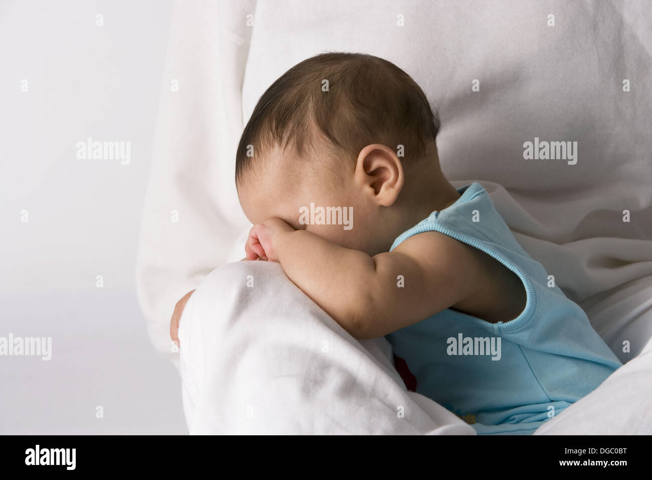 Baby rubbing his eyes Stock Photo Alamy