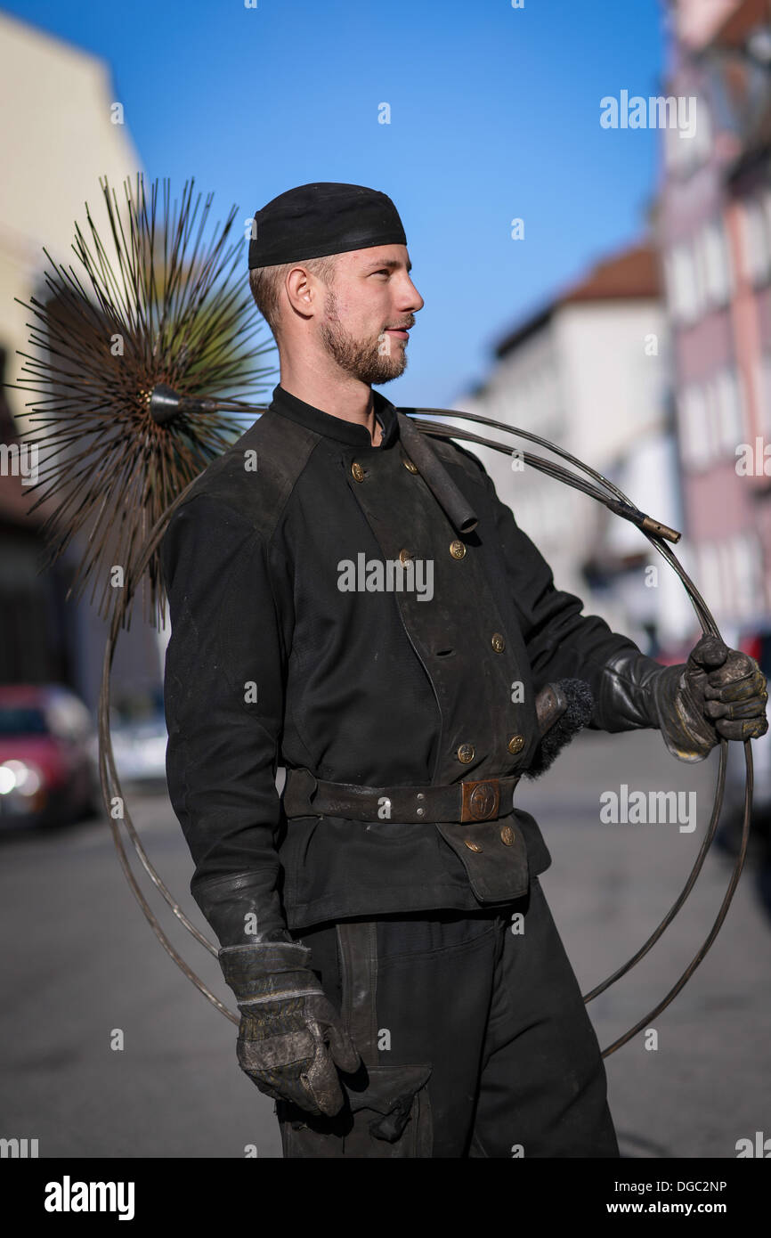 Bamberg, Germany. 18th Oct, 2013. Chimney sweeper Benjamin Loesel with a broom on his sholder in Bamberg, Germany, 18 October 2013. The star-shaped broom is used to clean chimneys. Photo: DAVID EBENER/dpa/Alamy Live News Stock Photo