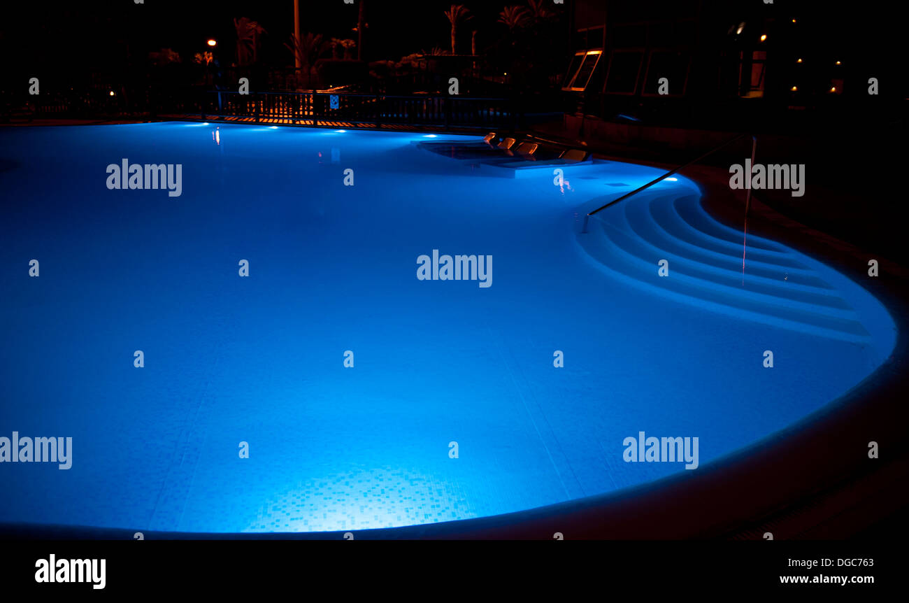 holiday swimming pool illuminated at night Stock Photo - Alamy