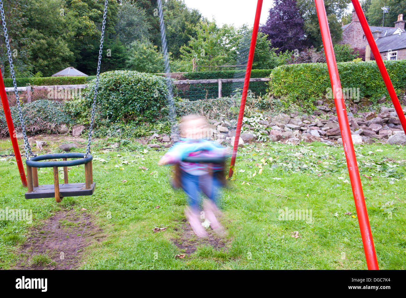 toddler on swing with motion blur Stock Photo