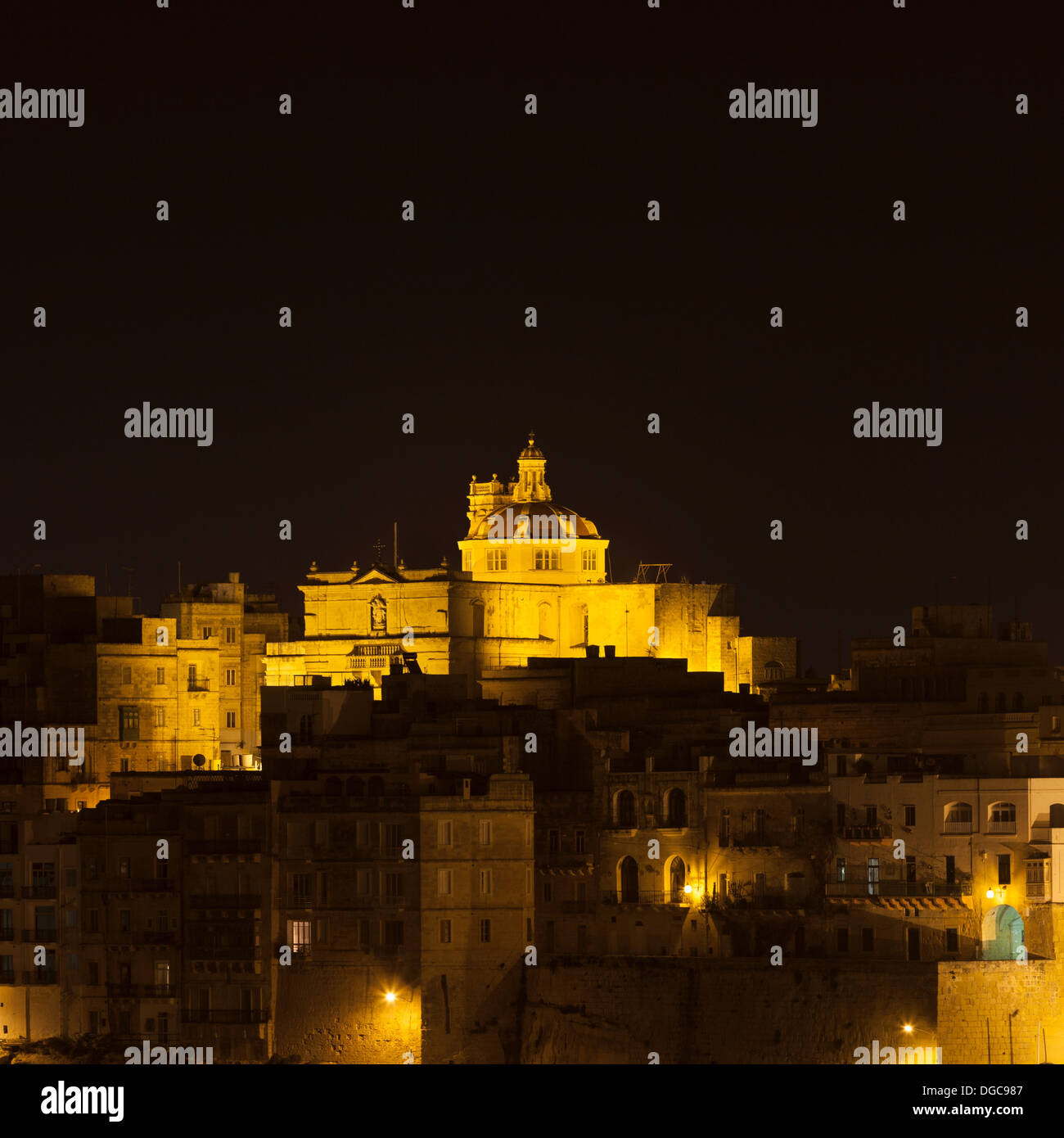 St Philip's Church over city at night, Senglea, Malta Stock Photo