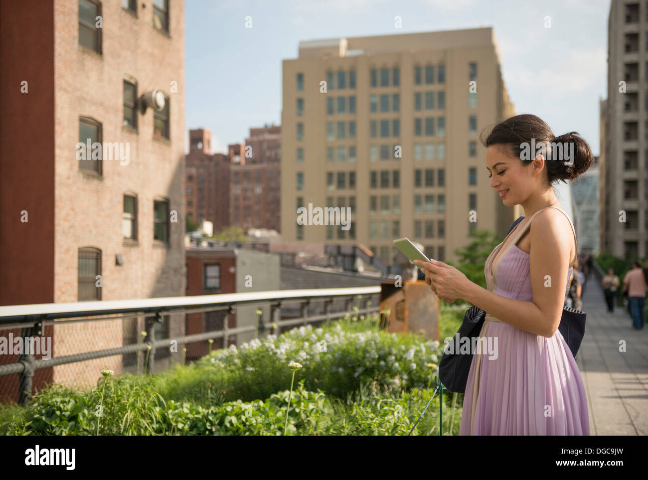 Mid adult women using digital tablet in High Line Park, New York City Stock Photo