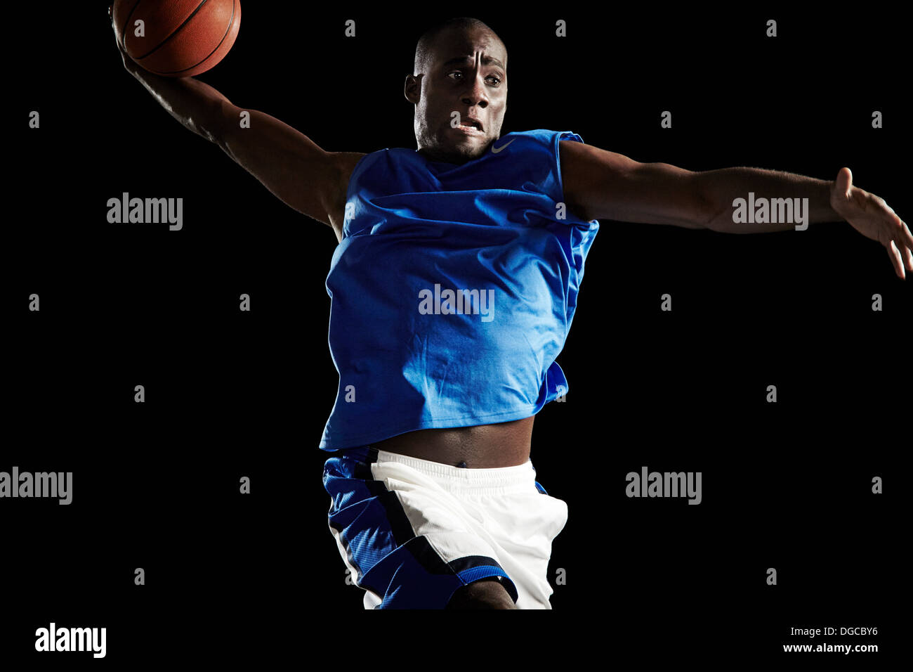 Male basketball player shooting ball Stock Photo - Alamy