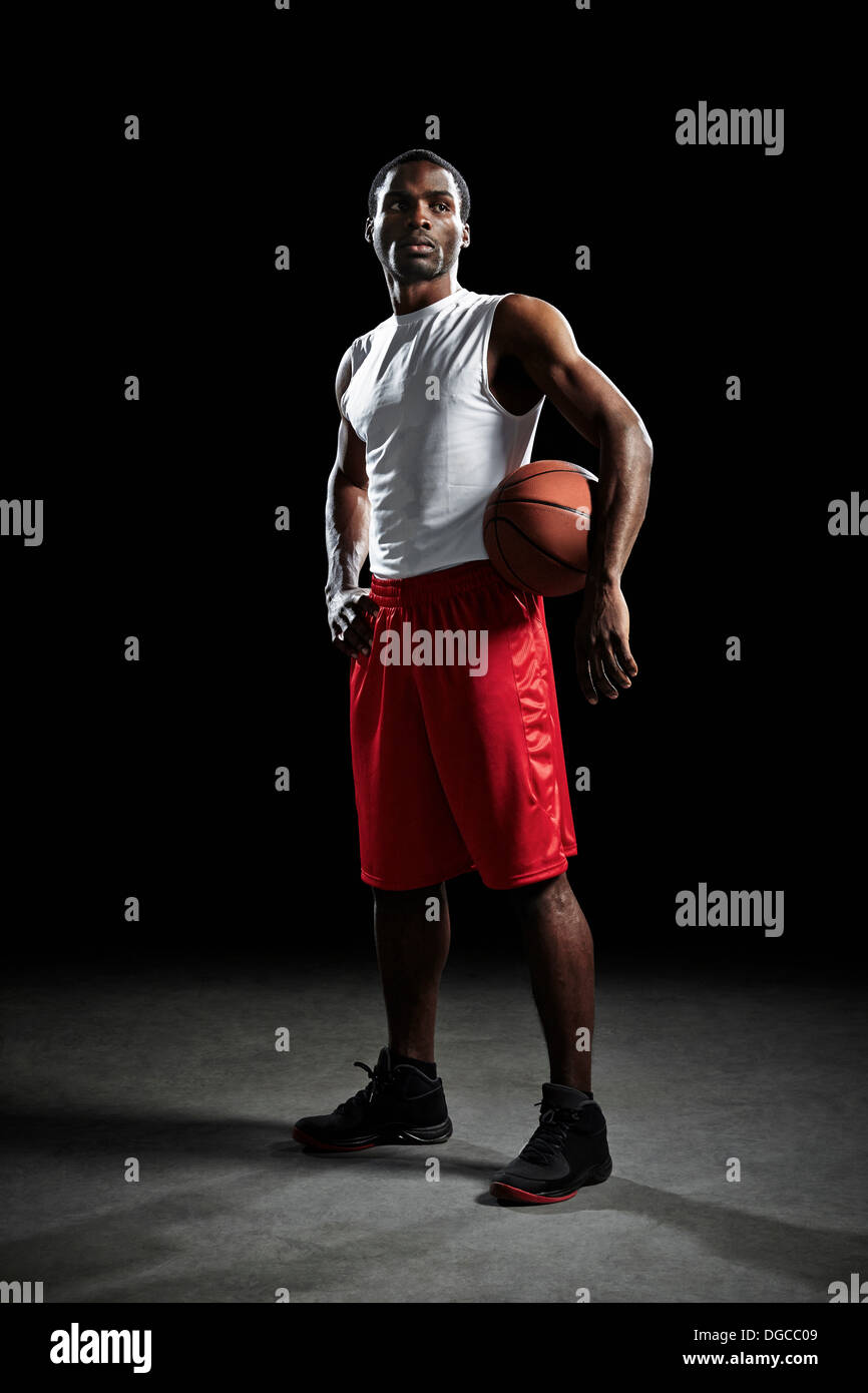 Studio shot of basketball player with ball Stock Photo