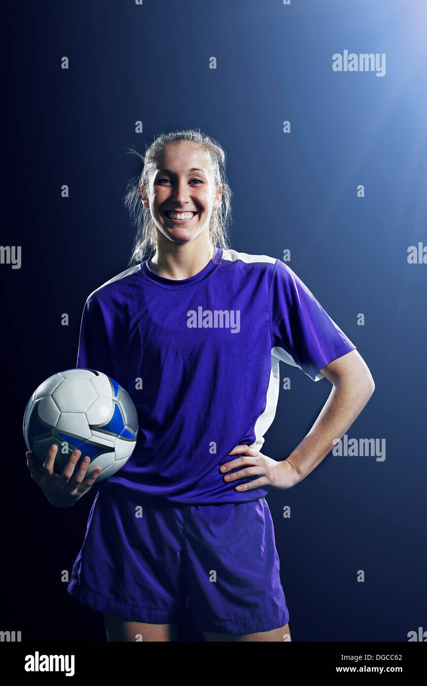 Studio shot of female soccer player with ball Stock Photo