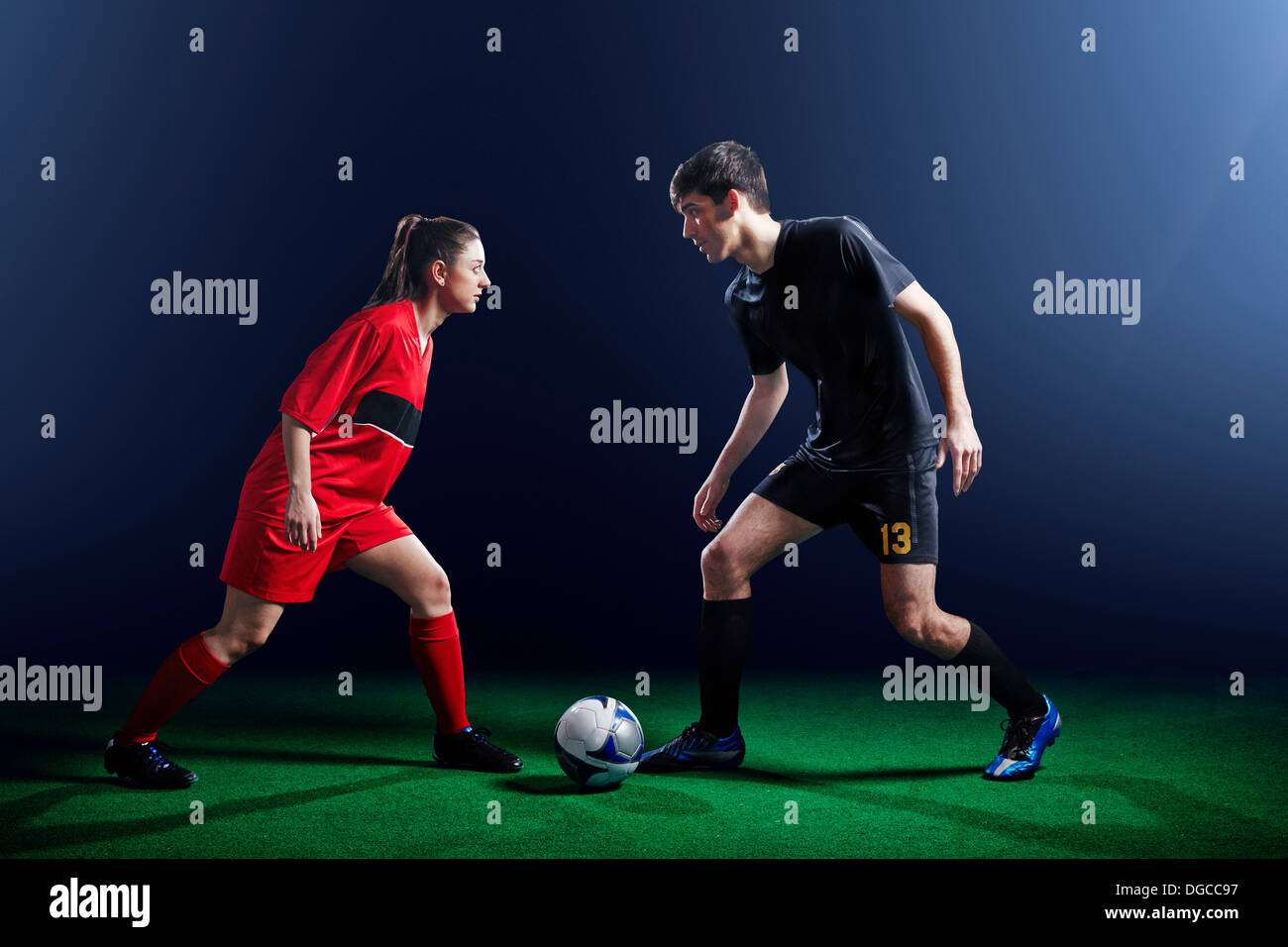 Male and female soccer players with ball Stock Photo Alamy