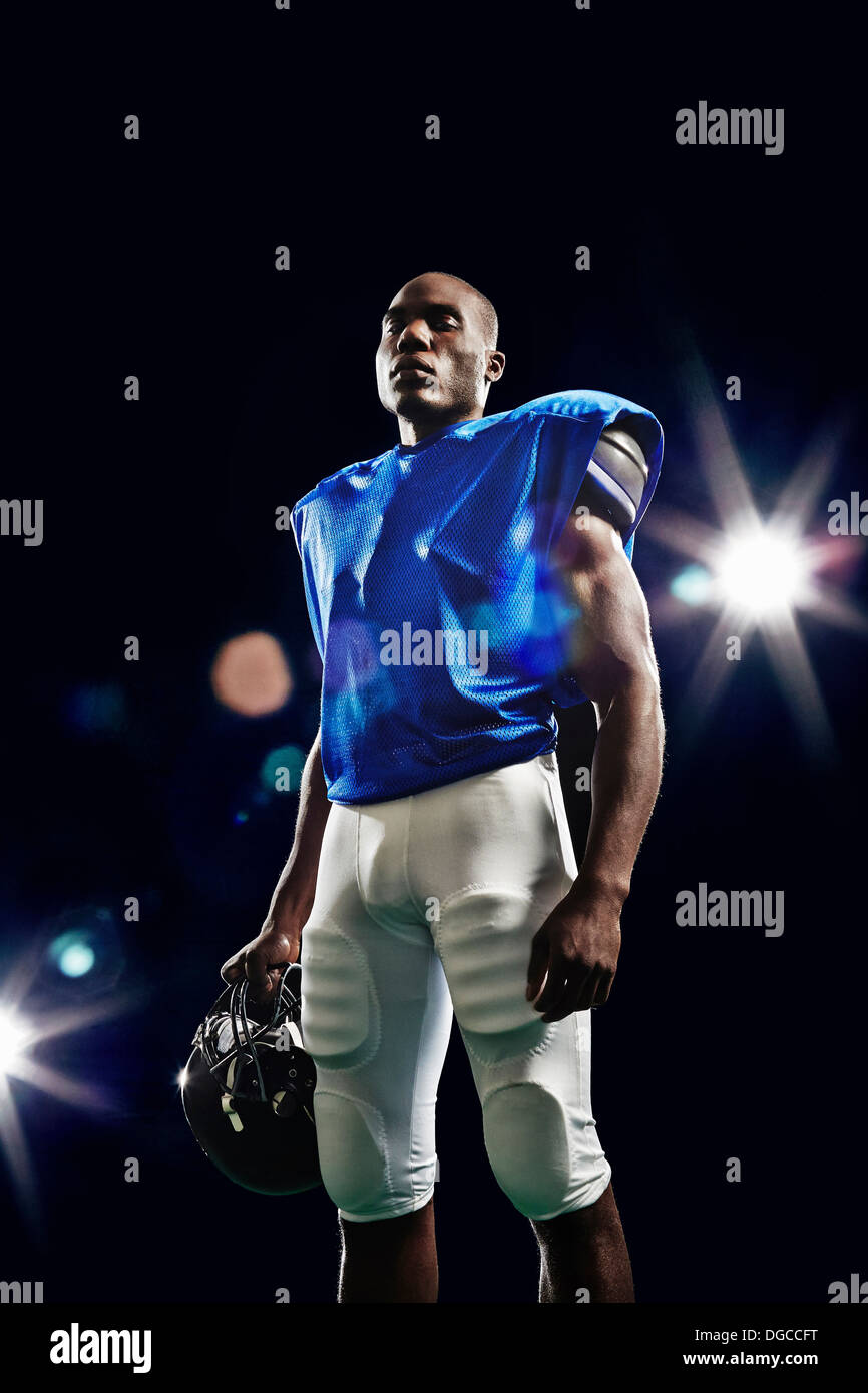 Portrait of american football player holding helmet Stock Photo Alamy
