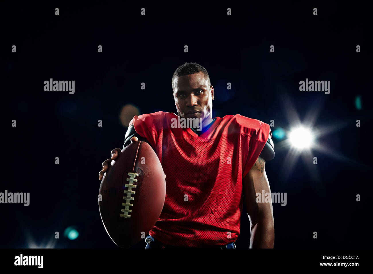 Young football player holding ball hires stock photography and images