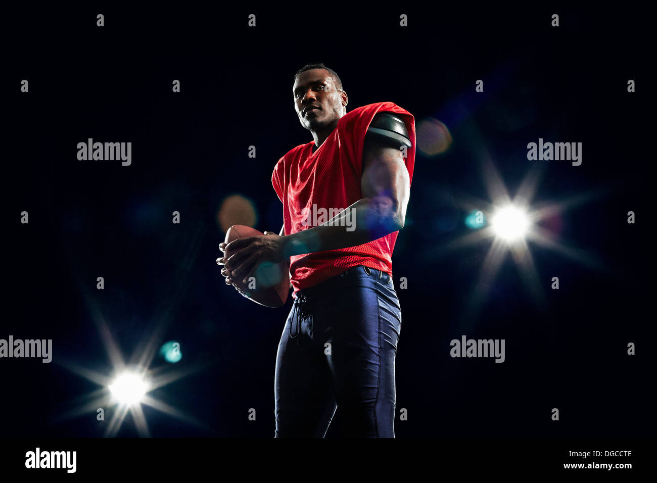 Portrait of american football player and ball Stock Photo