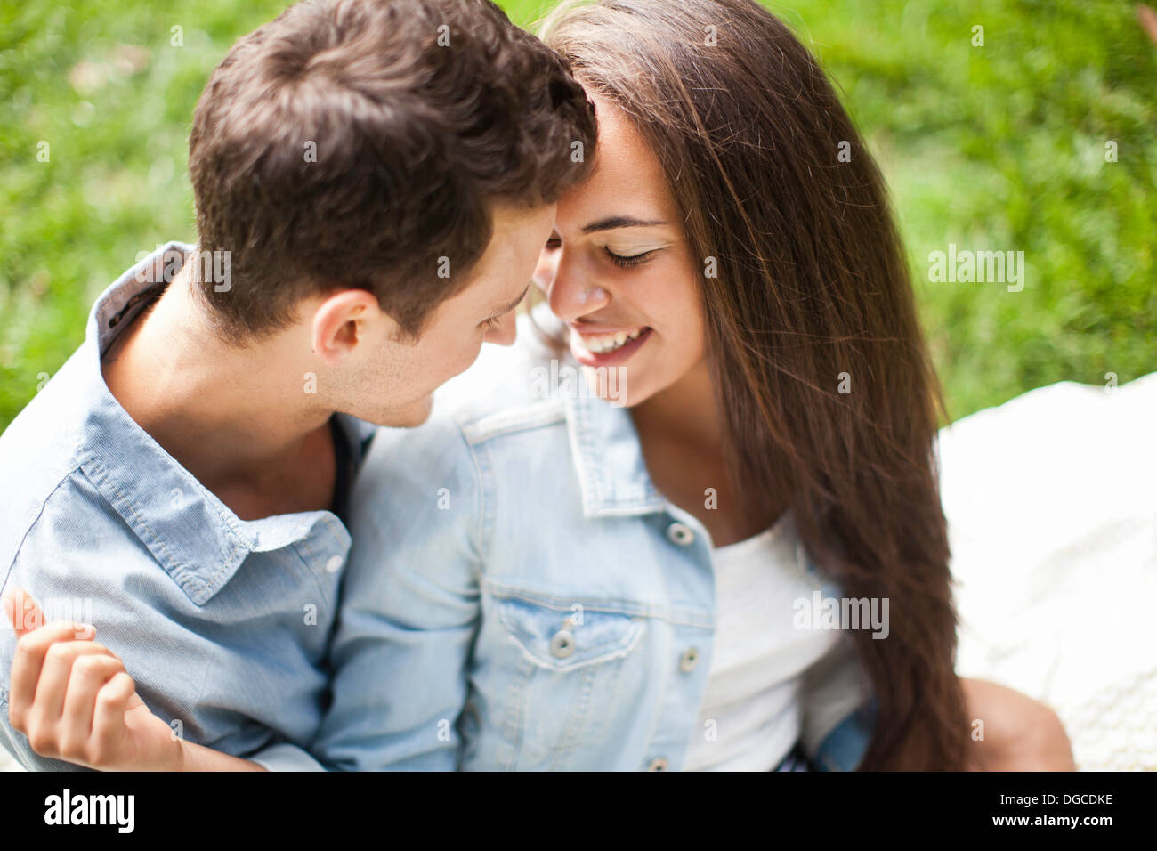 Young couple face to face in park, close up Stock Photo