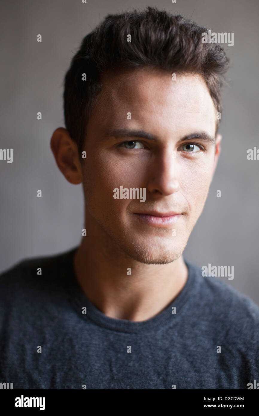 Young man smiling, studio shot Stock Photo