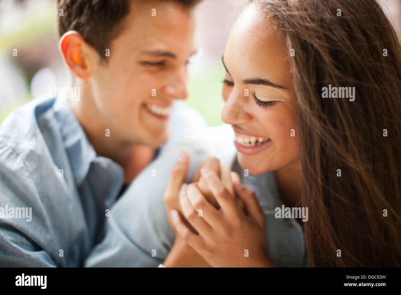Young couple holding hands and smiling, close up Stock Photo