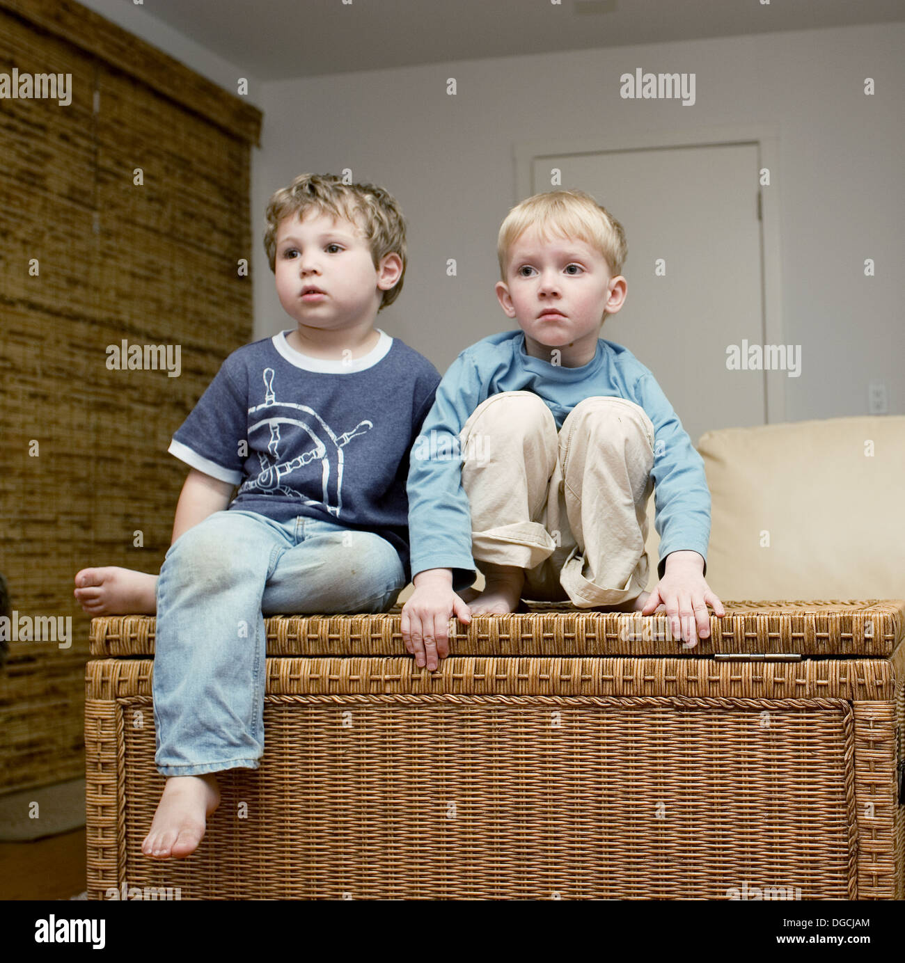 Two fouryearold boys watching television Stock Photo Alamy