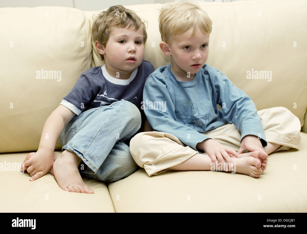 Two fouryearold boys watching television Stock Photo Alamy