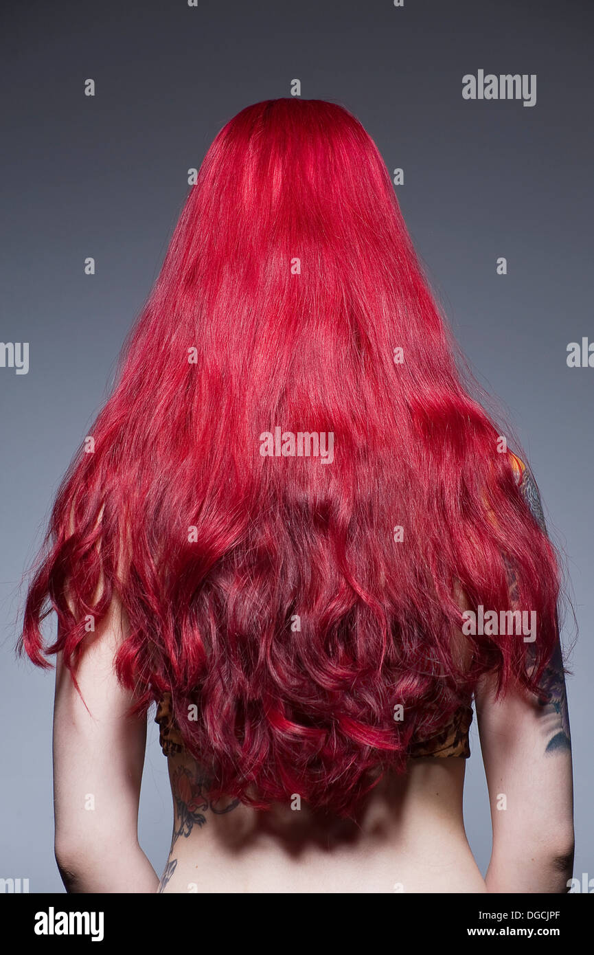 Young woman with long red hair, studio shot Stock Photo