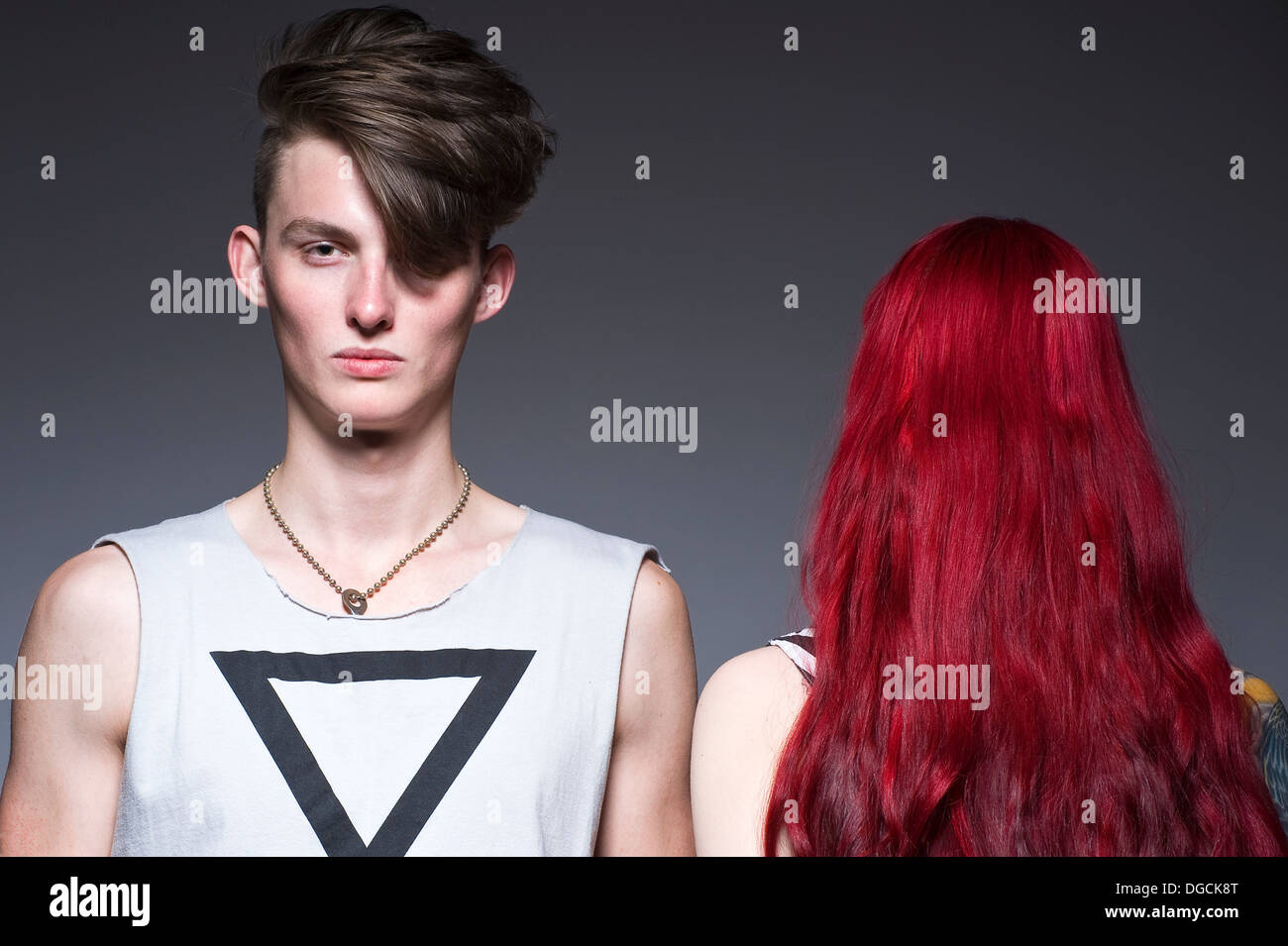 Young man standing next to woman with red hair, portrait Stock Photo
