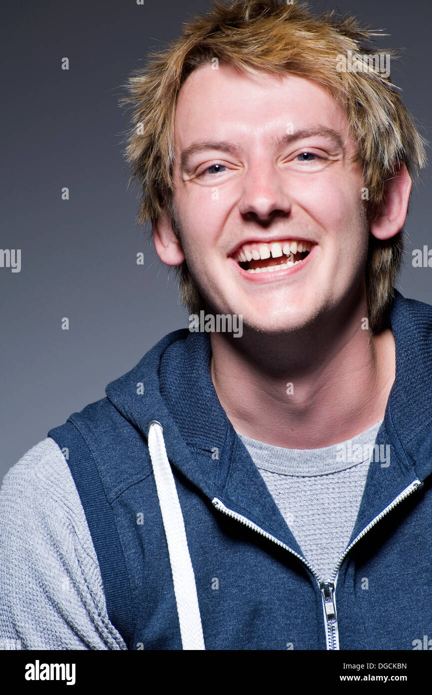 Young man in laughing in studio, portrait Stock Photo