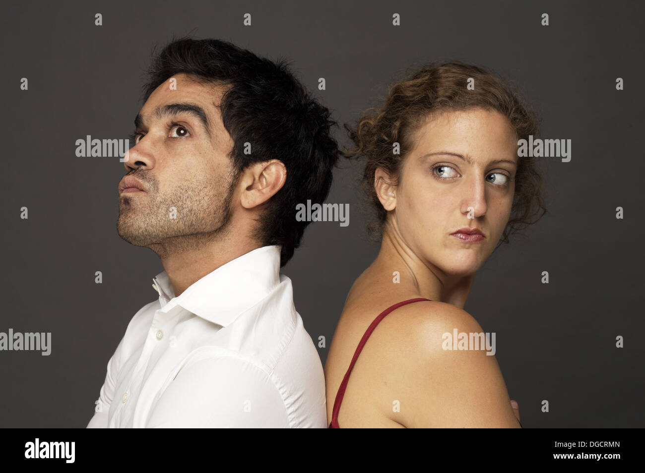 Woman and man back to back in studio Stock Photo Alamy