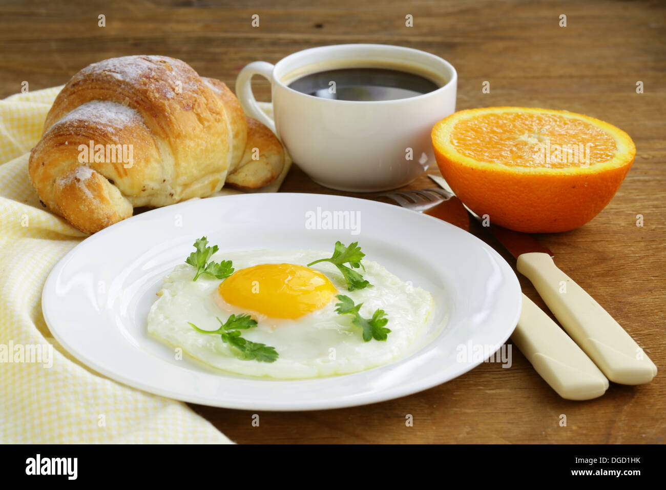 Continental breakfast croissant, fried egg, toast and oranges Stock